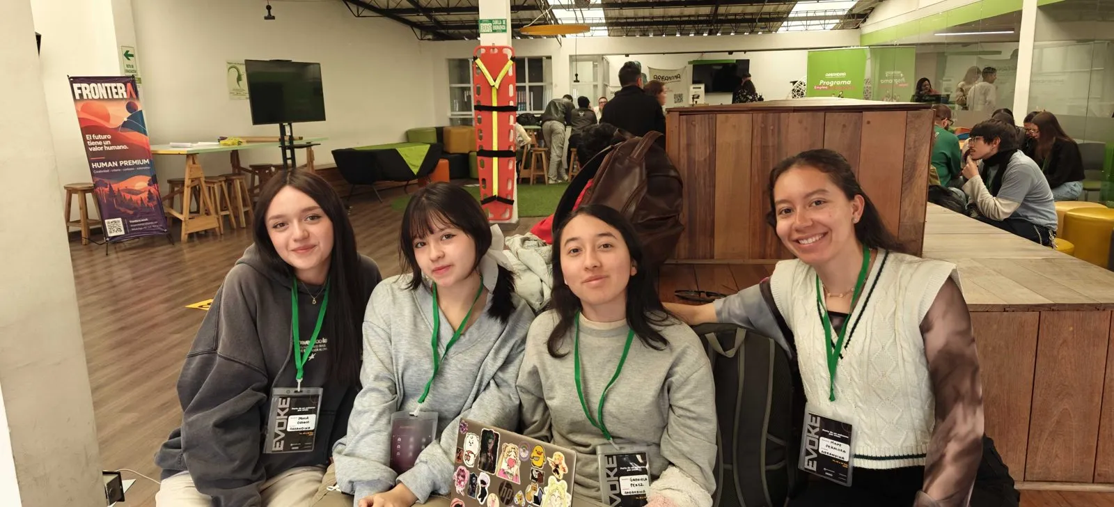 Four participants with Evoke badges smile at the camera.