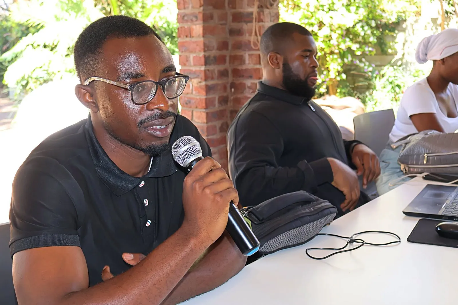 A participant speaks into a microphone during a team session.